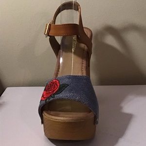 Denim platform with embroidered flower.